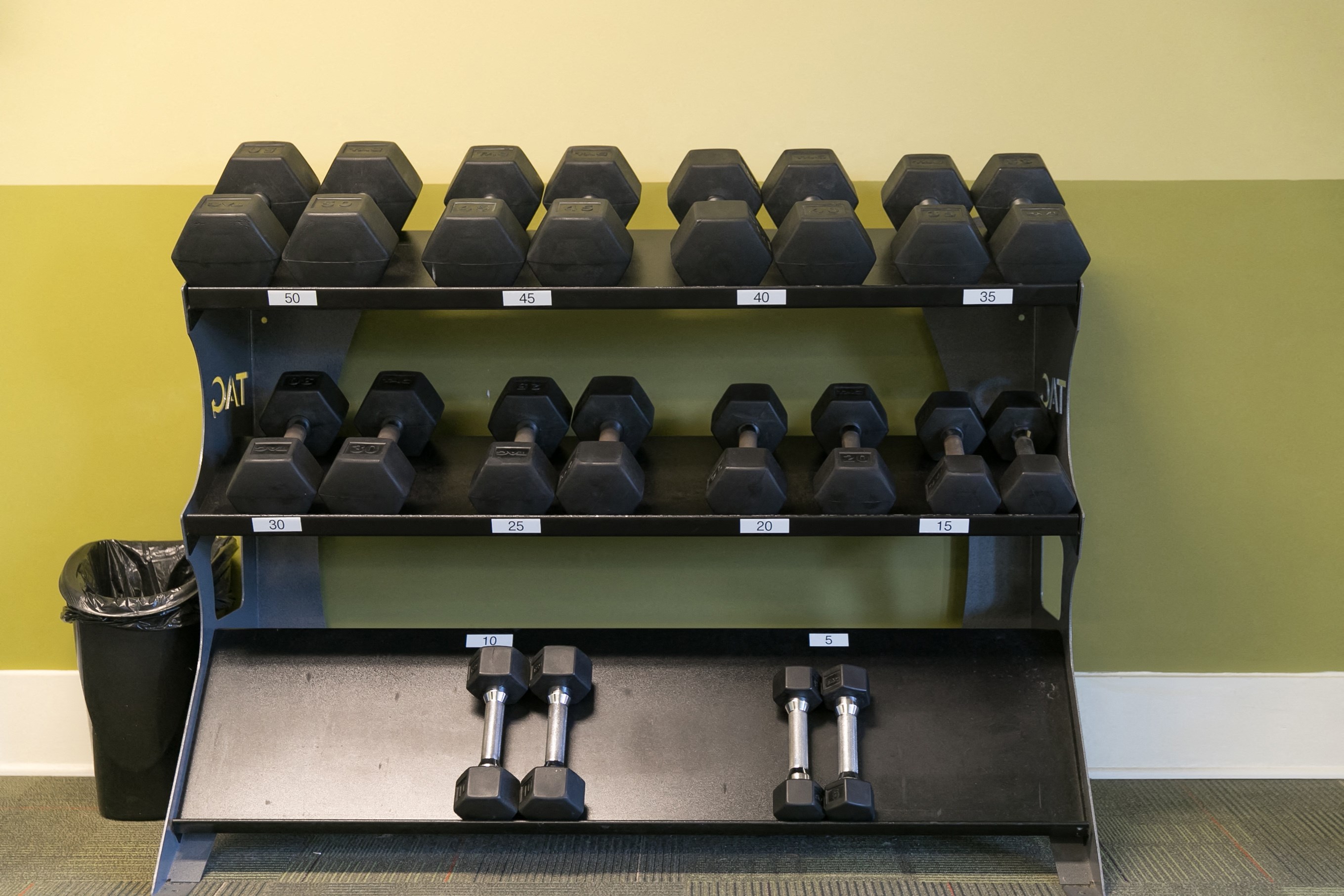 Weight rack inside an indoor fitness center.